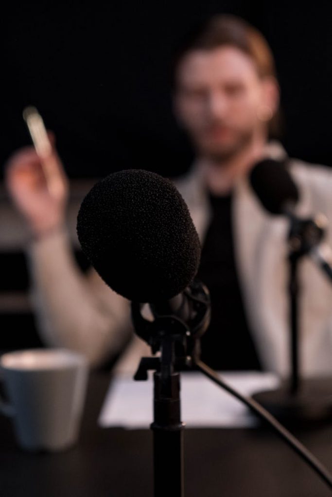 Close-up of a microphone with a blurred background, ideal for podcast themes.